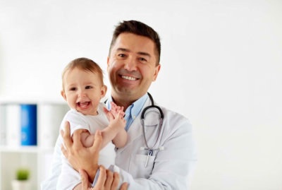 doctor carrying a happy child